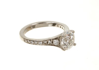 Lot 636 - Diamond single stone ring with a round brilliant cut diamond weighing 1.51cts in platinum four claw setting with graduated diamond set shoulders on platinum shank. Accompanied by a Diamond Report b...