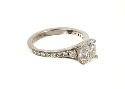 Lot 636 - Diamond single stone ring with a round brilliant cut diamond weighing 1.51cts in platinum four claw setting with graduated diamond set shoulders on platinum shank. Accompanied by a Diamond Report b...