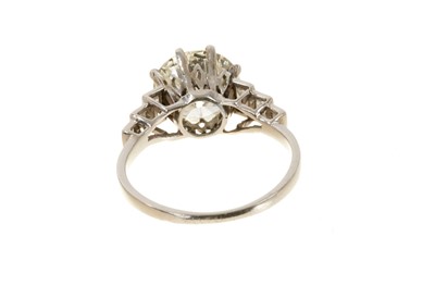 Lot 632 - Art Deco diamond single stone ring with a round old European cut diamond estimated to weigh approximately 2.5cts in eight claw setting flanked by six baguette cut diamonds to the stepped shoulders...