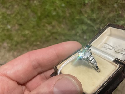 Lot 632 - Art Deco diamond single stone ring with a round old European cut diamond estimated to weigh approximately 2.5cts in eight claw setting flanked by six baguette cut diamonds to the stepped shoulders...