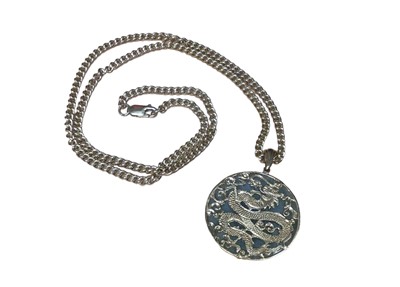 Lot 13 - Chinese green jade/green hard stone disc pendant with 9ct gold dragon mounts