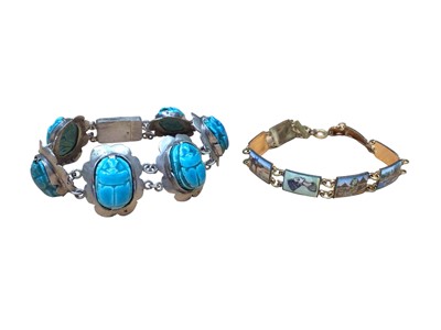 Lot 40 - Egyptian white metal and glazed turquoise scarab beetle bracelet, together with an Egyptian enamelled panel bracelet (2)