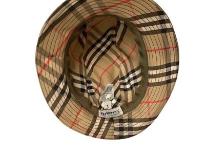 Lot 2136 - Burberrys’ women's hats, two felt trilby style, navy canvas bucket hat and a green canvas hat with feather.