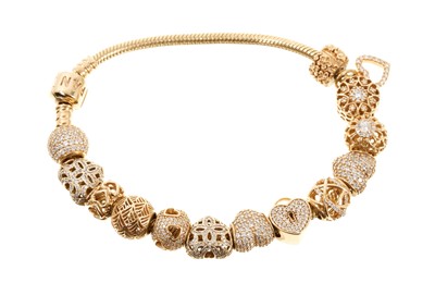 Lot 719 - Pandora 14ct gold charm bracelet with 14 gold and gem-set Pandora charms