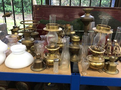 Lot 58 - Collection of brass oil lamps and glass shades, a model ship, etc