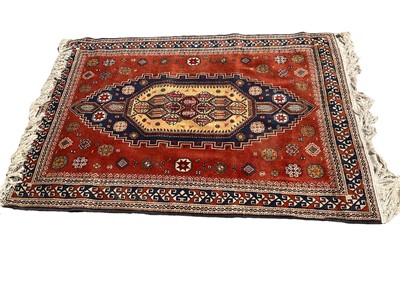 Lot 1588 - Persian design rug on red ground