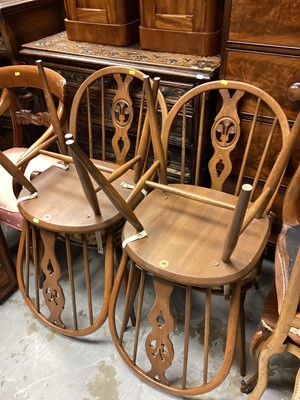 Lot 1289 - Ercol drop leaf dining table on splayed legs joined by X frame stretchers, 112cm x 183cm together with a set of four Ercol chairs