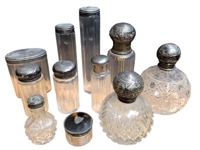 Lot 96 - Collection of mostly silver topped glass vanity jars and perfume bottles