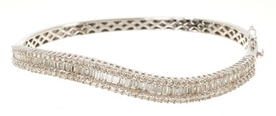 Lot 634 - Diamond bangle with baguette cut and brilliant cut diamonds in 18ct white gold. Estimated total diamond weight approximately 3.53cts