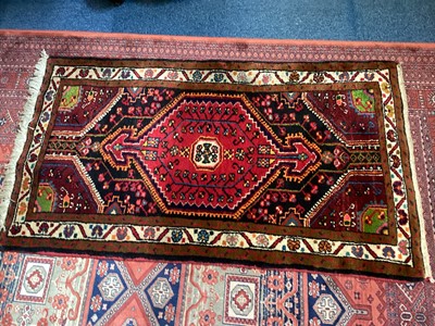 Lot 1503 - Eastern rug with central medallion on red, brown, cream and black ground, 136cm x 79cm