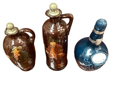 Lot 43 - Two Royal Doulton Kingsware whisky flagons, together with Spode and another Doulton whisky flagon, and a pair of Doulton figural ashtrays