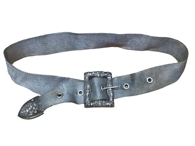 Lot 128 - Eastern white metal mesh belt with figure decoration to the buckle, 72cm long