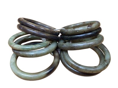 Lot 133 - Ten green hard stone polished bangles