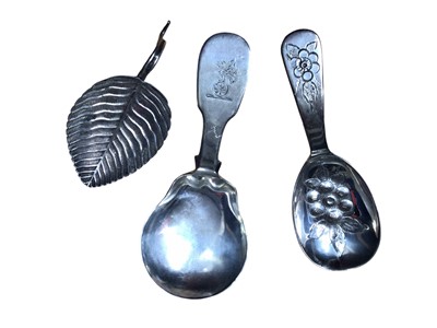 Lot 164 - Georgian silver caddy spoon with engraved crest, Georgian silver caddy spoon in the form of a leaf and one other silver caddy spoon