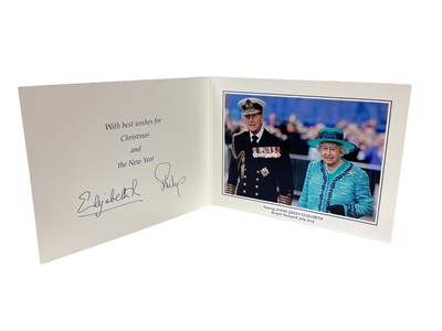 Lot 151 - H.M.Queen Elizabeth II and H.R.H. The Duke of Edinburgh, signed 2014 Christmas card with twin gilt ciphers to cover, colour photograph of the Royal couple at the naming of HMS Queen Elizabeth to th...