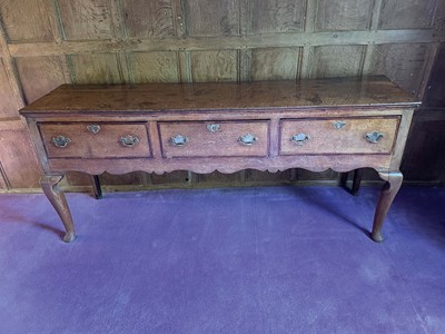 Lot 1050 - George III oak dresser base with three drawers, brass handles and cabriole legs, 187cm wide x 49cm deep x 82cm high
