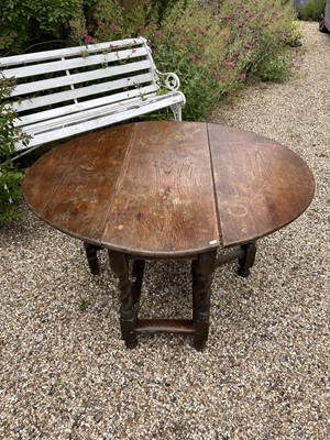 Lot 1080 - 17th century oak drop leaf table, with oval hinged top on barley twist and block understructure, 132 x 106cm