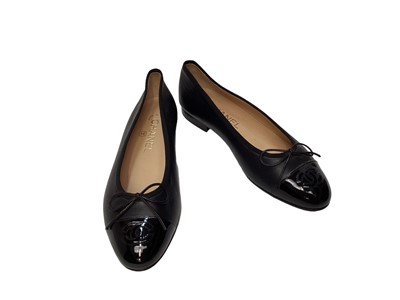 Lot 2079 - Chanel black leather shoes with bow detail and CC logo on patent toe cap with dust bag. Size 36 1/2.  Unworn.