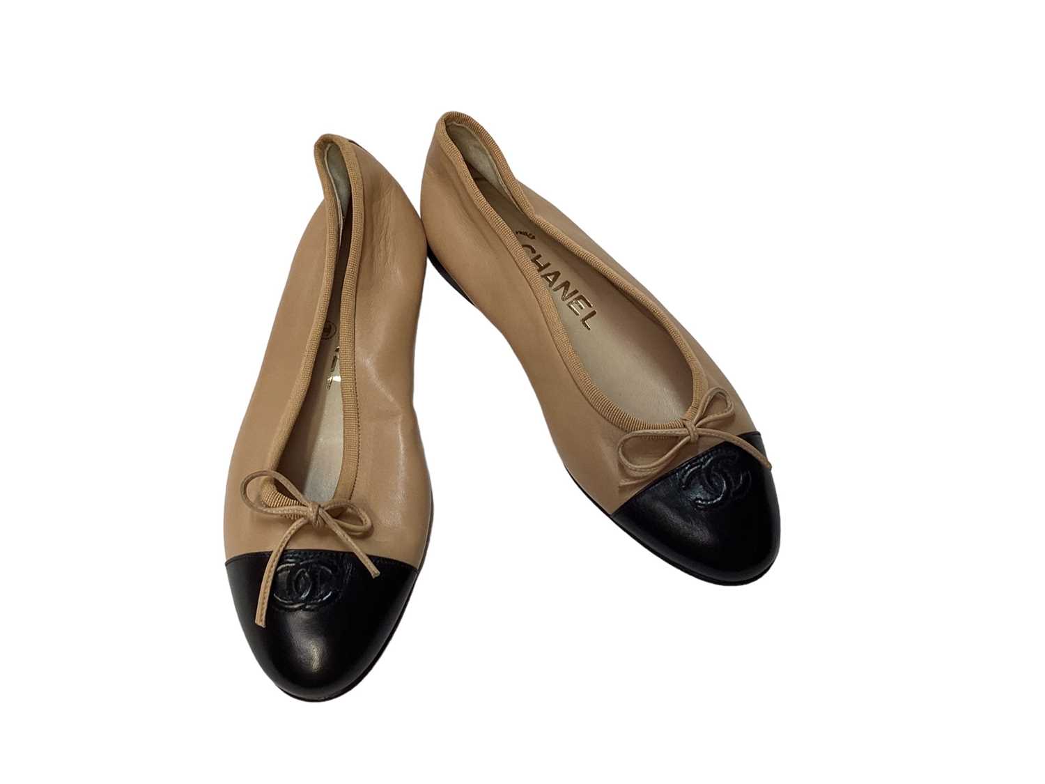 Lot 2082 - Chanel shoes in dark cream leather with CC logo on black patent toe cap with soft dust bags.  Size 36.  Unworn