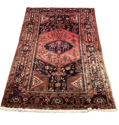 Lot 1164 - Eastern rug with central medallion on red and blue ground, 200cm x 131cm