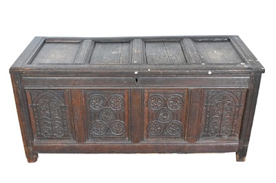 Lot 1101 - 17th century carved oak coffer, with four panel top and foliate carved four panel front on stiles, 130cm wide x 53cm deep x 61cm high