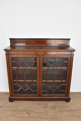 Lot 1105 - Edwardian limed mahogany and satin wood inlaid low bookcase by Maples & Co., with gallery back and enclosed by pair of astragal glazed doors on plinth base, 122cm wide x 39cm x 123cm high, makers l...