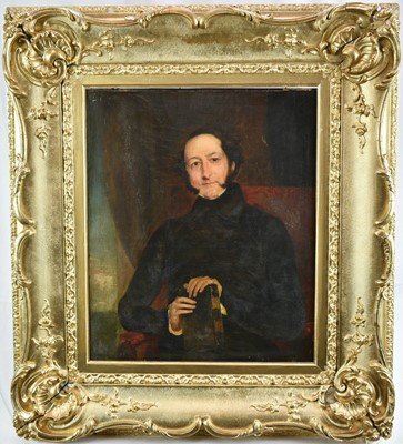 Lot 896 - English School, circa 1800, oil on canvas, a portrait of a cleric holding a book, in an interior, 45 x 37cm, in gilt frame