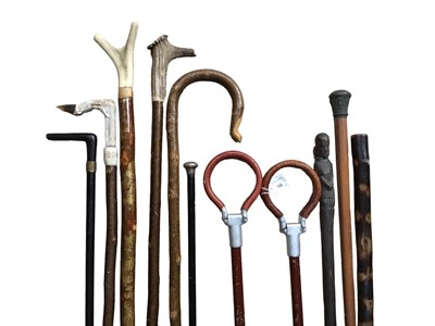 Lot 780 - Two folding shooting sticks, two horn handled walking canes, silver mounted cane and a selection of others