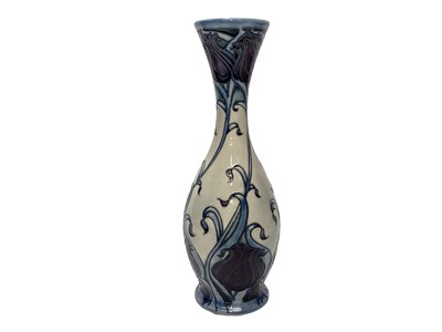 Lot 1146 - Moorcroft pottery vase decorated with blue and purple flowers on cream ground, signed Emma Bossons, numbered 3 of 4, dated 14.11.09, 36.5cm high, boxed