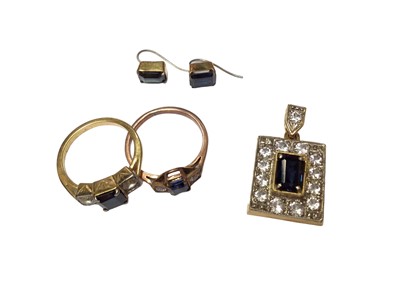 Lot 33 - Sapphire and synthetic white stone pendant in 18ct gold setting, two similar three stone rings in yellow metal setting and a pair of earrings