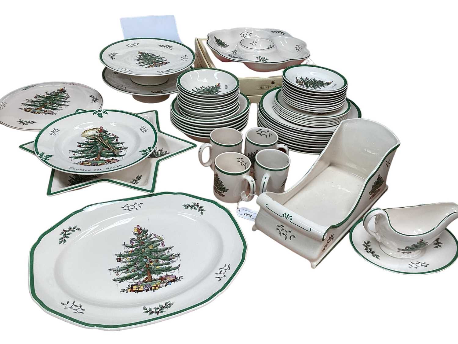 Lot 1232 - Spode Christmas Tree pattern service, including 10 tea plates, 10 dinner plates, 6 side plates, 6 large bowls, 10 small bowls, gravy boat and stand, 4 mugs, star-shaped dish, meat platter, gateau p...