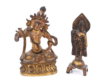 Lot 687 - Early miniature Tibetan gilt bronze deity figure, together with a Chinese gilt bronze deity figure on lotus base