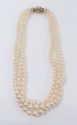 Lot 527 - Three strand cultured pearl necklace with 9ct gold pearl cluster clasp
