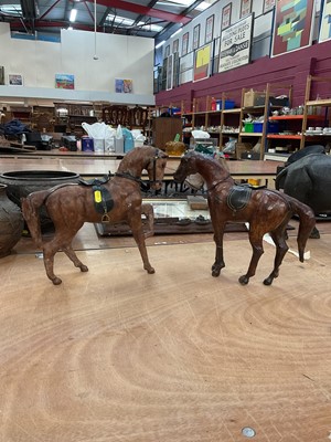 Lot 474 - Manner of Liberty and Co; two leather horses, 30cm (2)