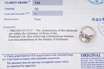 Lot 692 - Fine diamond single stone ring, the round brilliant cut diamond weighing 3.38 carats, in a rub-over setting, surrounded by a border of twenty-five brilliant cut diamonds with fourteen diamonds to t...