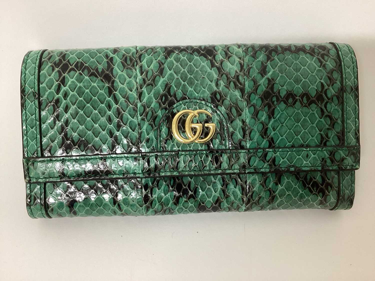 Lot 2072 - Gucci green python skin clutch purse with soft bag.
