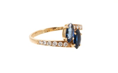 Lot 739 - Cartier sapphire and diamond cross-over ring with two marquise cut blue sapphires in a cross-over design with graduated brilliant cut diamonds to the shoulders on 18ct yellow gold shank, signed Car...