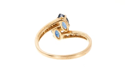 Lot 739 - Cartier sapphire and diamond cross-over ring with two marquise cut blue sapphires in a cross-over design with graduated brilliant cut diamonds to the shoulders on 18ct yellow gold shank, signed Car...