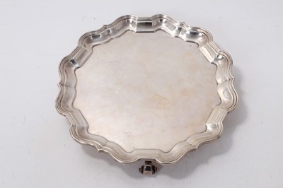 Lot 514 - Edwardian silver salver of circular form, with pie crust border, raised on three scroll feet, (London 1900), maker Thomas Bradbury & Sons, 12ozs, 20.5cm in diameter.