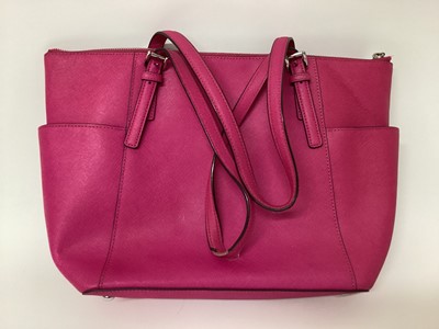 Lot 2079 - Michael Kors Tote bag in Cerise with a gold Michael Kors purse. With large dust bag.