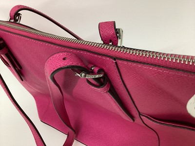 Lot 2079 - Michael Kors Tote bag in Cerise with a gold Michael Kors purse. With large dust bag.