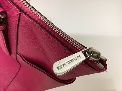 Lot 2079 - Michael Kors Tote bag in Cerise with a gold Michael Kors purse. With large dust bag.