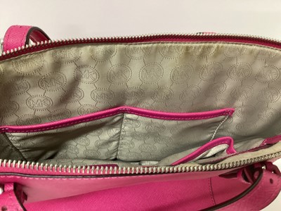 Lot 2079 - Michael Kors Tote bag in Cerise with a gold Michael Kors purse. With large dust bag.