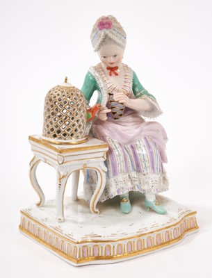 Lot 327 - A 19th century Meissen lace figure of a lady feeding her pet parrot, polychrome decorated, crossed swords mark with incised model number 'E4', 14.5cm high