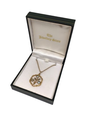 Lot 26 - Edwardian 9ct gold seed pearl and gem set open work floral pendant