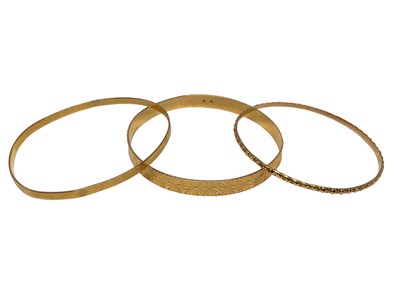 Lot 85 - Three yellow metal bangles