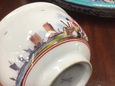 Lot 168 - Meissen tea bowl, painted in coloured enamels with figures and shipping in a continuous estuary landscape, the interior unusually painted in purple monochrome with figures in a harbour scene, circa...