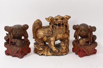 Lot 874 - Antique Chinese carved gilt Buddhist lion and pair of carved guardians