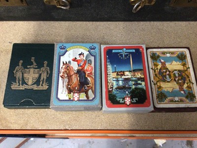 Lot 75 - Three packs of vintage unopened playing cards depicting the Queen taking a salute at Trooping the Colour 1952, Festival of Britain 1951 and D-Day 1944, together with a pack of fortune telling cards...