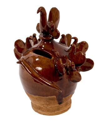 Lot 49 - 19th century treacle glazed pottery money box, decorated with birds, and a slug trailing across the front, 17.5cm high